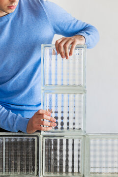 Person Stacks Glass Blocks For Modern Home Design