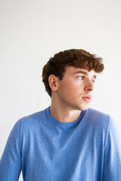 Contemplative Young Man In Blue Sweater Portrait