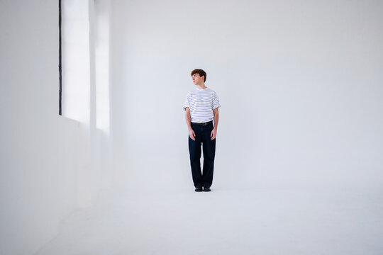 Man In Striped T-Shirt In Minimal White Studio