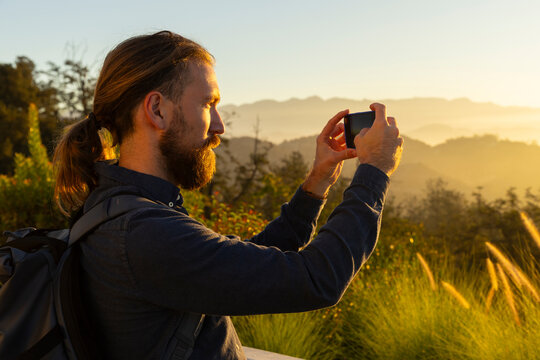 Handsome mobile phone photographer portrait