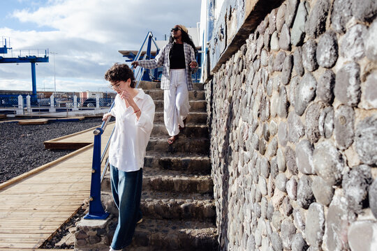 Diverse women walking down Gran Canaria port stairs