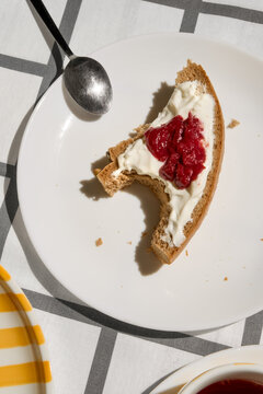Piece of Bread With Cream and Jam on a White Plate 
