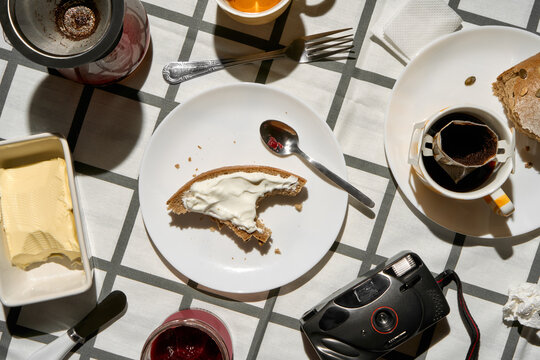 Breakfast With Coffee, Bread, Butter, Camera on Checkered Tablecloth