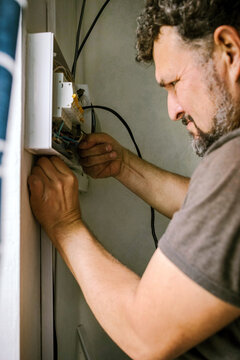 Electrician works on circuit breaker panel