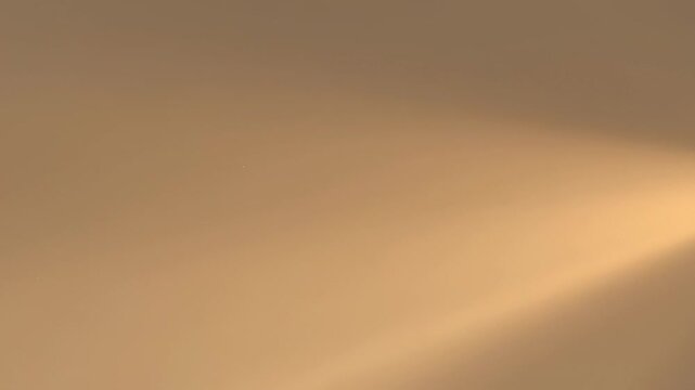 ?Mesmerizing golden light beams creating stunning dynamic patterns across a smooth surface