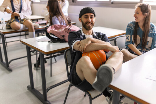 Students relaxing in classroom with playful attitude