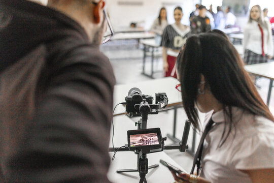 Teacher showing recorded video to student in classroom