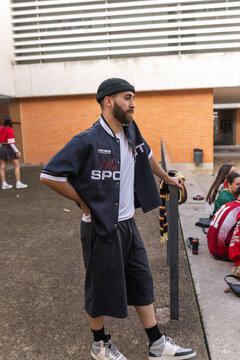 man student waiting in school courtyard