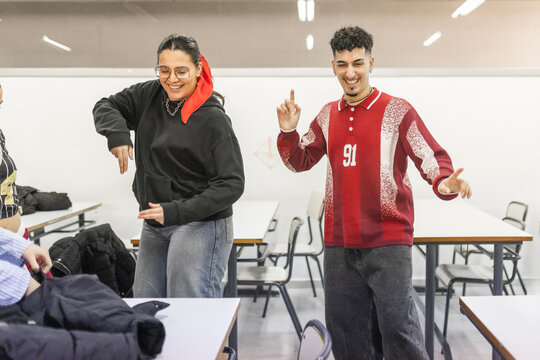 Students dancing together between classes at school