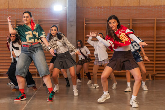 Students performing a group choreography in school gym