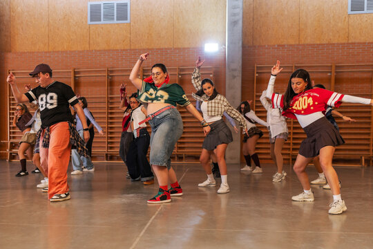 Students performing a group choreography in school gym