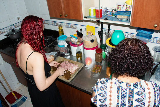Women Prepare Food in a Kitchen With Various Items on the Counter