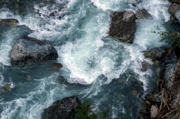 Cold stream in the mountains (whitewater), big rocks. Caucasus nature.