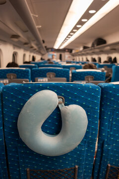 Neck Pillow Resting on Seat in Train During Travel