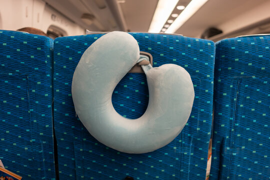 Neck Pillow Resting on Seat in Train During Travel