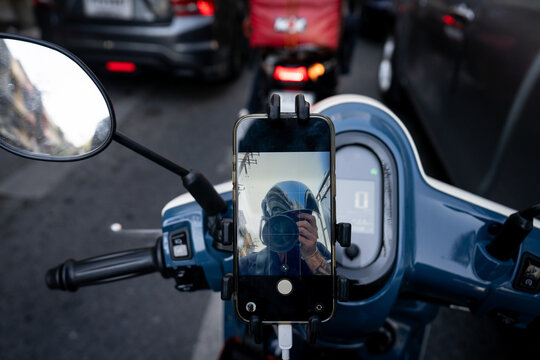 Selfie with a big DSLR camera inside of a mobile phone on a motorcycle