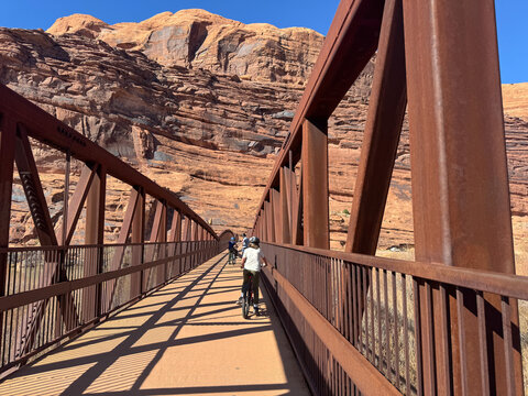 Cycling Across Canyon Bridge in Moab