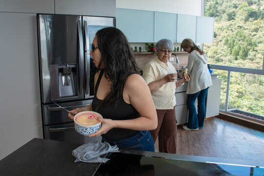 Family Members Cooking in Modern Kitchen With a View of Nature