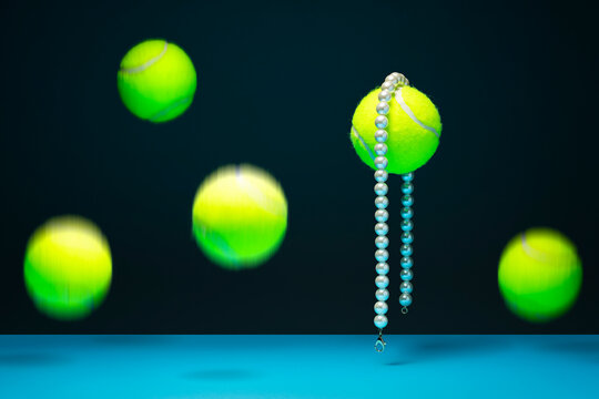 Luxury pearl necklace on a tennis ball