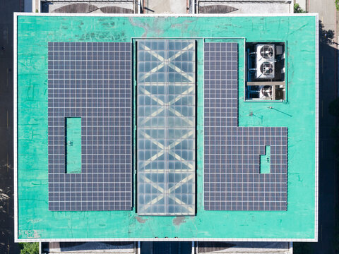 Aerial View of Solar Panels on Green Building Roof