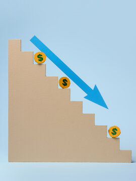 Financial concept of money going down the stairs, representing a loss