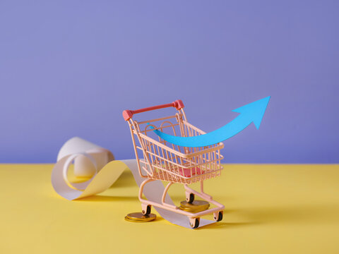 Shopping cart with arrow representing financial growth