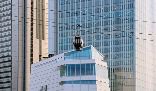Urban Gondola Passing in Front of a Skyscraper.