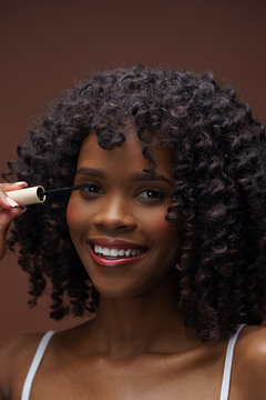 Lady applying mascara