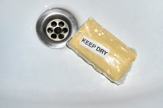 Soap wrapped in protective plastic with &ldquo;Keep Dry&rdquo; label in wet sink