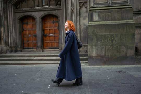 Woman in a cozy coat walks with joy