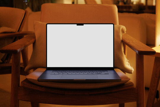 Laptop mockup with white screen in hotel lounge