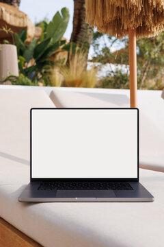 Laptop mockup with white screen at travel hotel lounge