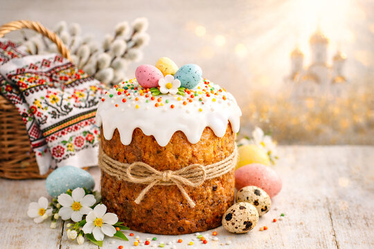 Easter background with traditional Orthodox Easter bread with icing and painted eggs against the backdrop of an Orthodox church. With space for text.