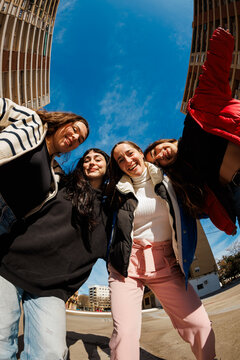 Friends gather in urban area under blue sky during daytime