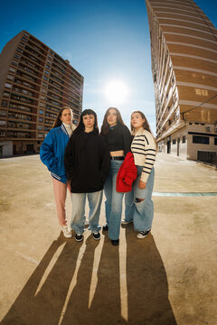Group of friends standing together in a city setting during the 