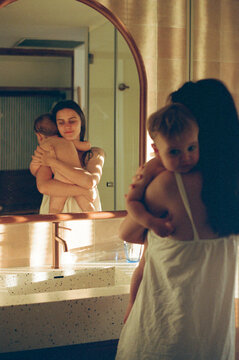 Woman Embracing Child in Bathroom Mirror Film Photo