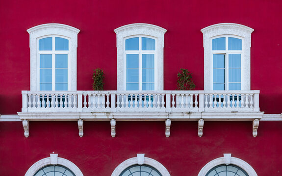 Elegant architecture with red fa&Atilde;&sect;ade and white balcony