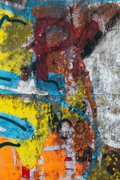 Colorful abstract wall with peeling graffiti