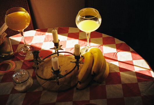 Drinks and Bananas on a Checkered Table in a Cozy Setting