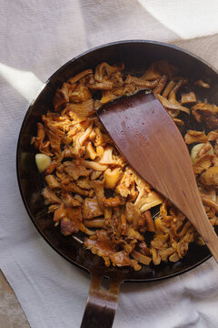 Galletti mushrooms in a Skillet With a Wooden Spoon