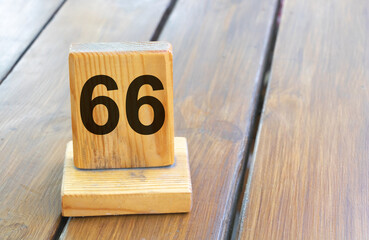 Wooden priority number 66 on a plank tab