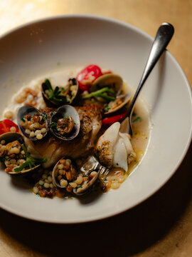 White fish with mussels and cous cous