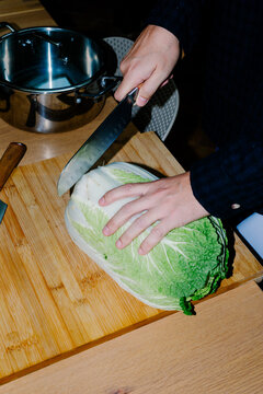 Anonymous person using a knife to chop cabbage