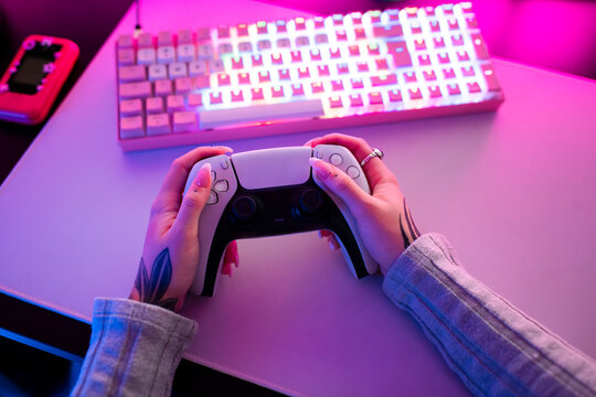 Female hands holding Gaming Controller 