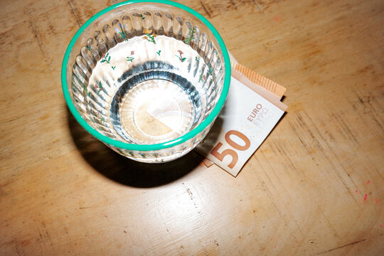 Fifty Euro Banknote under water glass. 