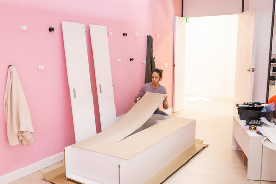 Woman finishing wardrobe assembly inside her business