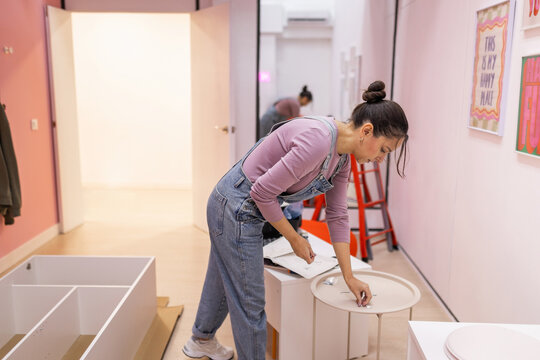 Woman selecting screws for furniture assembly