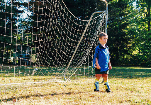 Youth Soccer Player Stands in Goal Outside