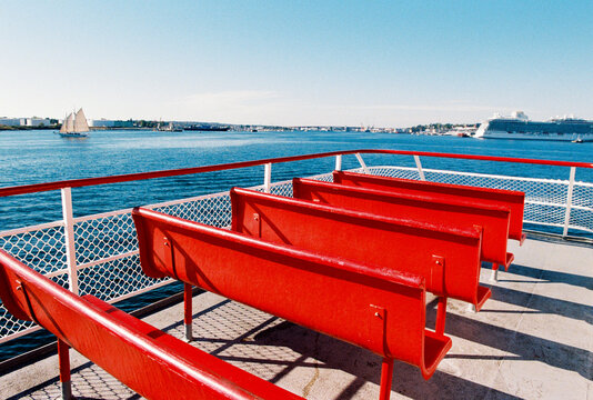 Row of Empty Red Benches on the Deck of a Ferry in Portland, Maine