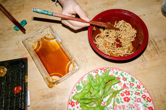 Eating Noodles and Edamame at home. 